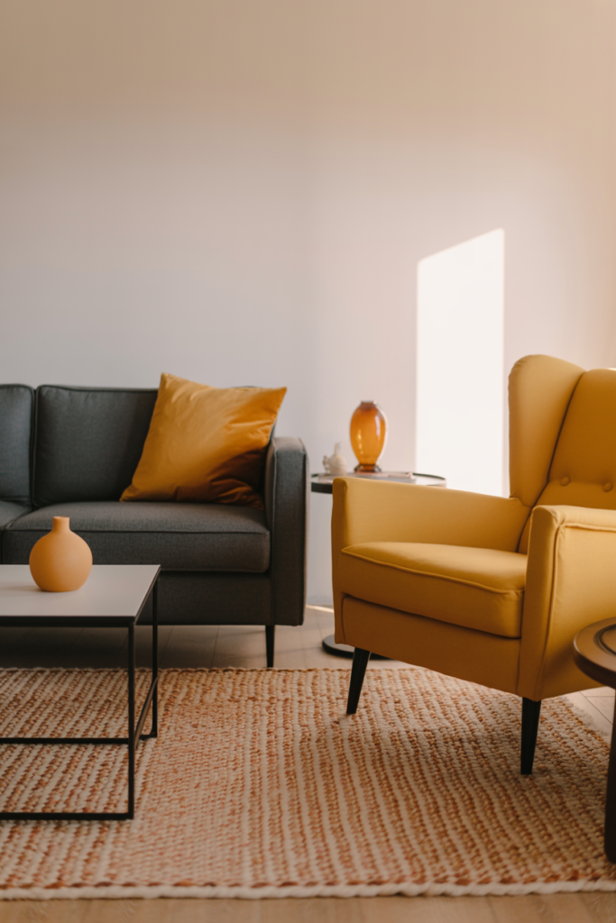 Mustard yellow colour bridging vintage armchair and modern sofa in a cohesive vintage-modern living room
