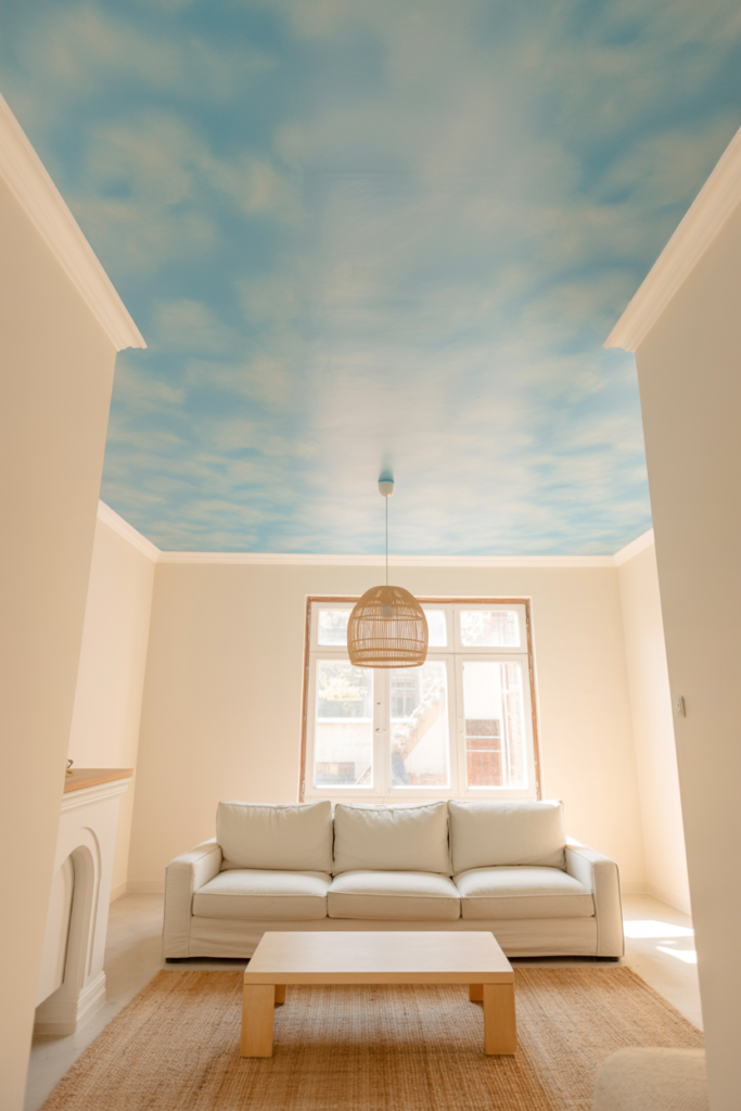 Soft muted sky blue Mellow Flow painted ceiling in a bright white living room creating a cosy fifth wall effect
