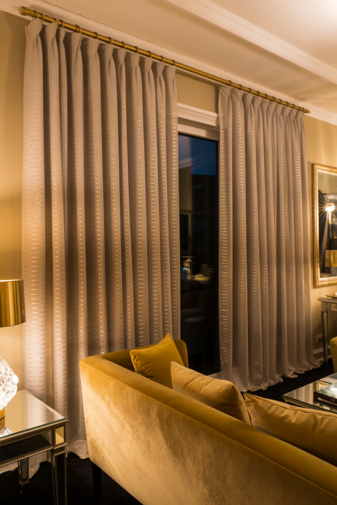 Champagne curtains with gold metallic thread accents in a glamorous living room